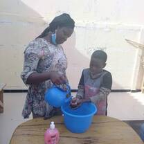 Teaching the children how to wash their hands
