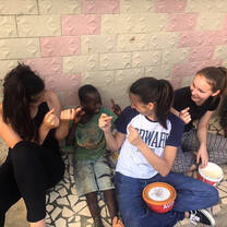 Volunteers playing games with the children