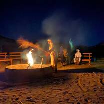 Lankey's students having fun around a campfire.