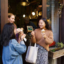 Three smiling students holding gelato