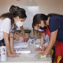 Nursing students bent over writing