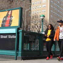Two NYLC students walk near an NYC subway station
