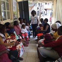 A nurse doing reproductive health education to young ladies within a community setup
