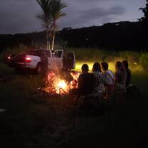 A group of people sitting around a bonfire