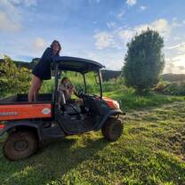 Some volunteers driving a farm vehicle