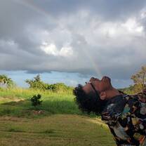 A man appears to be swallowing a rainbow