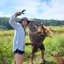 People holding some freshly harvested cassava