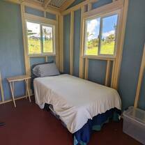 A small, cozy bedroom with a view