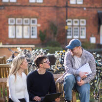 students talk on a bench
