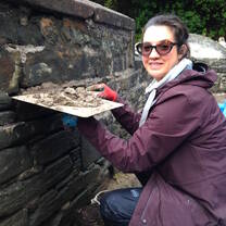 Volunteer repoints bridge wall