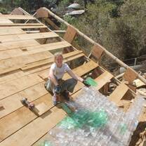 Volunteers roofing a home