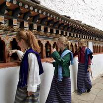 girls spinning the prayer wheels