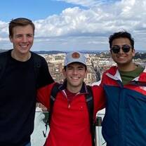 Students posing on overlook above city of Rome