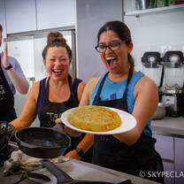 A proud student after cooking a Spanish dish