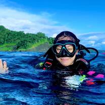 A diver smiles in the water 