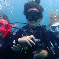 a group takes a selfie underwater