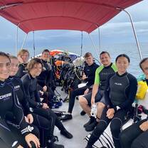 a group of divers on a boat  