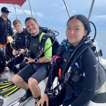 a diver smiles on a boatt 