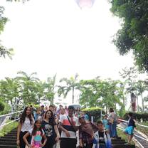 students smiling in front of greenery