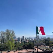 The Mexican flag flies by the Mexico City Skyline