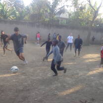 Volunteers with the players in a match after training