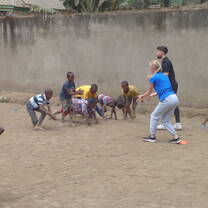 Volunteers training kids different football technics
