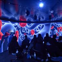 Group of health students watching a large surround screen