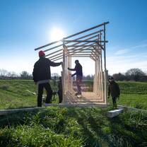 Architecture students building a structure outside