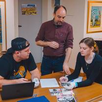 CYA students looking through photo archives with professor