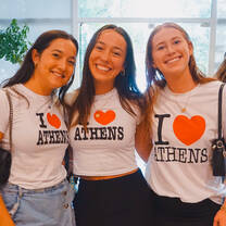 Three CYA students with I heart Athens shirts