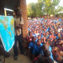 TWESA members donating world maps at Bwiba primary school
