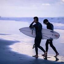 two surfers walking