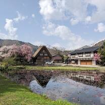 japanese style house with pink cherry blossoms