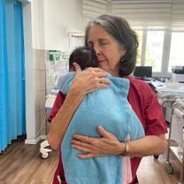 Volunteer holding a newborn