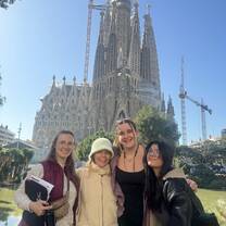 People standing in front of the Sagrada Familia