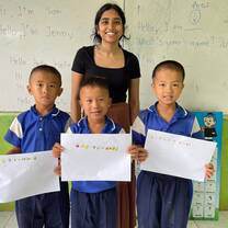 Volunteer with kids holding diplomas