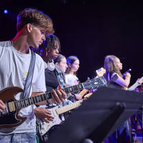 Participants playing musical instruments during concert