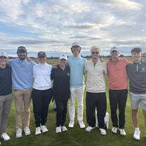 Students participating in a summer golf study program in Scotland practicing on a historic golf course.
