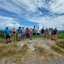 a group poses for a photo on a vista