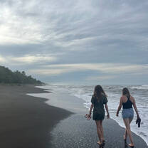 two girls walk on a beach