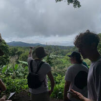 a group with their back turned the camera in the jungle 