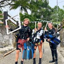 divers pose holding their equipment