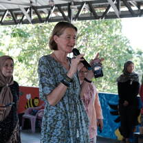 A volunteer hosting a session at a community event