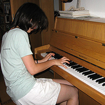 Participant playing piano at the house