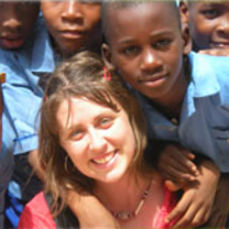 Smiling children surround their volunteer teacher in Nigeria