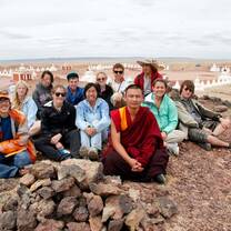 group of students posing with monk in Mongolia