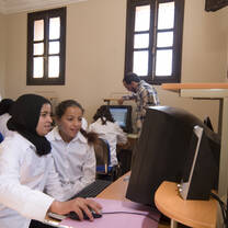 Volunteers helping in a computer room