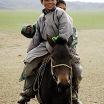 A Nomad boys riding their horse