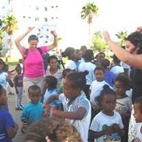 Volunteers singing and dancing with Israeli children.