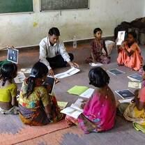 volunteers talking with children in India
